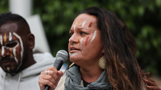 Antonia Burke addresses the media and crowd in front of the Federal Court of Australia.