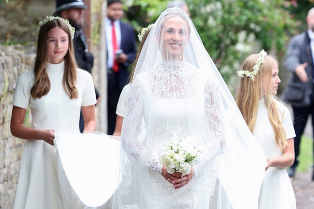 The bride’s dress was designed by Emilia Wickstead and her train was carried by Peter Phillips’s daughters Savannah (left) and Isla.