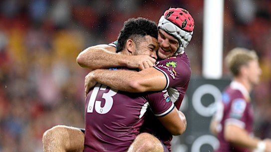 Hunter Paisami and Fraser McReight celebrate the Reds’ narrow win.