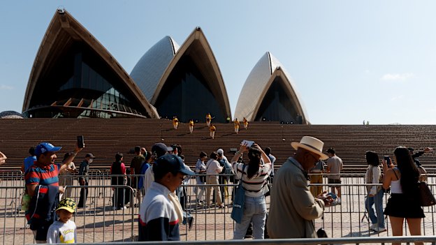 People funnel through barriers at the Opera House