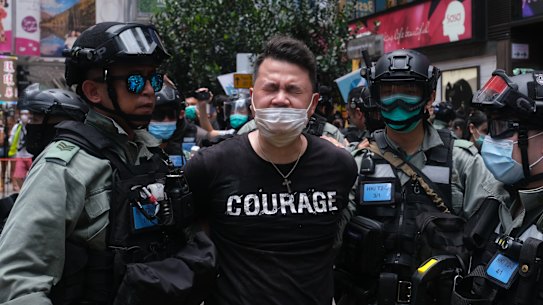 Andrew Wan, a pro-democracy lawmaker, is arrested by riot police during a protest in Hong Kong on Wednesday.