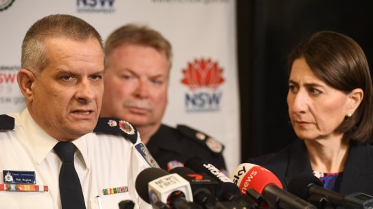 Rob Rogers (left) has won the support of Premier Gladys Berejiklian  (right) and her cabinet to remain in the job as Rural Fire Service commissioner beyond his one-year appointment.