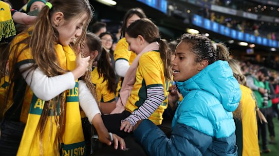 Mary Fowler signs an autograph after Friday night’s win over France.