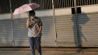 A woman holds an umbrella to shelter from the sun in Bangkok, Thailand. Authorities warned residents across Thailand to avoid outdoor activities due to extreme heat over the weekend. 