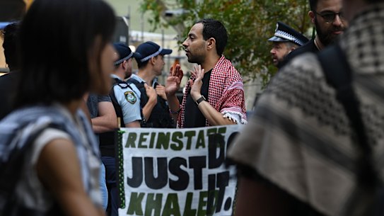 Palestinian activist and academic Fahad Ali (centre) attends a protest outside Creative Australia offices.