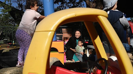 Emily Boon and her two-year-old son Kobe, centre, at SOCCS in Homebush West.