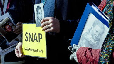 American members of the Survivors Network of those Abused by Priests (SNAP) hold pictures of victims in St Peter's Square ahead of the summit.