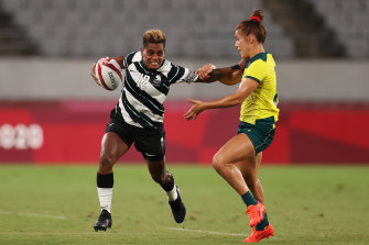 Fijiâ€™s Roela Radiniyavuni puts a fend on an Australian defender.