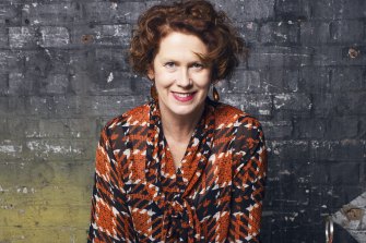 In her signature tartan, a self brand that began as a joke in Birmingham. She still has a pair of Doc Martens