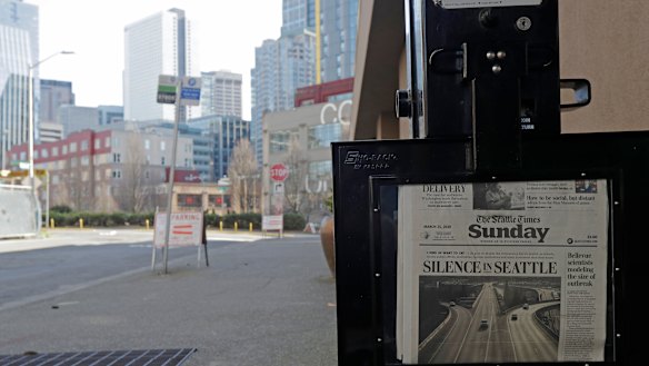 The street next to a Seattle Times newspaper box in front of the building that houses its newsroom is empty as the US economy takes a hit.