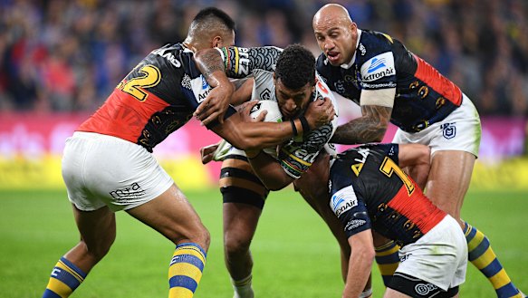 Ferguson helps bring down Viliame Kikau during a disappointing performance against the Panthers. 