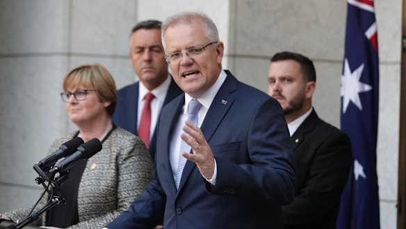 Prime Minister Scott Morrison, Minister for Defence Linda Reynolds, Minister for Veterans and Defence Personnel Darren Chester, second left, and Liberal MP Phil Thompson, right, announcing the national commissioner to examine veteran suicide in February. 