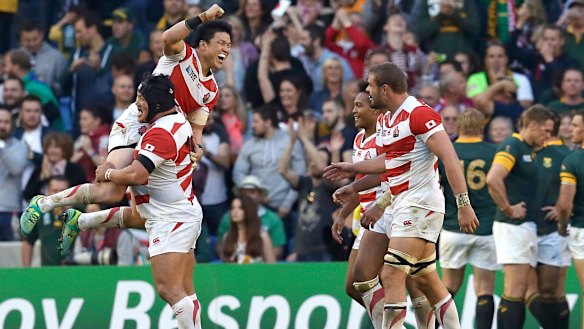 Japan's Brave Blossoms celebrate their upset win over South Africa at the 2015 Rugby World Cup.