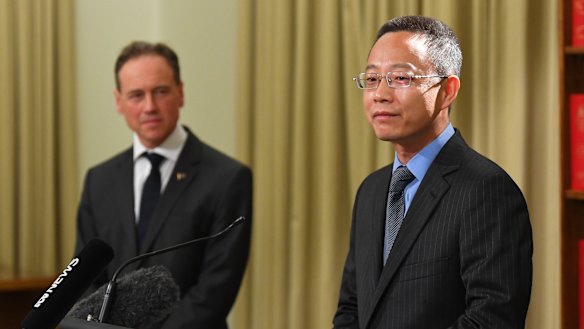 China’s consul-general for Victoria Zhou Long (right) and Health Minister Greg Hunt.