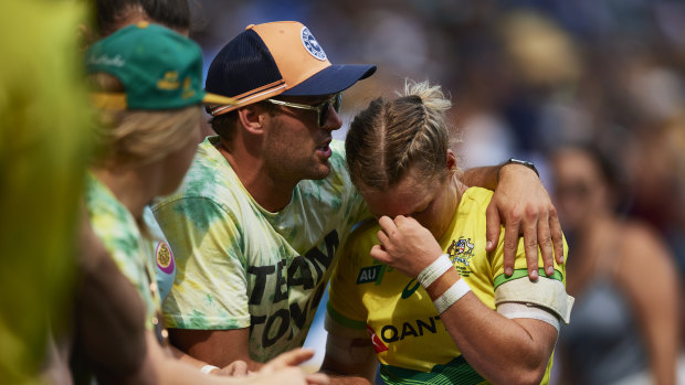 Devastated: Emma Tonegato is comforted after Australia's six-try loss to Canada. 