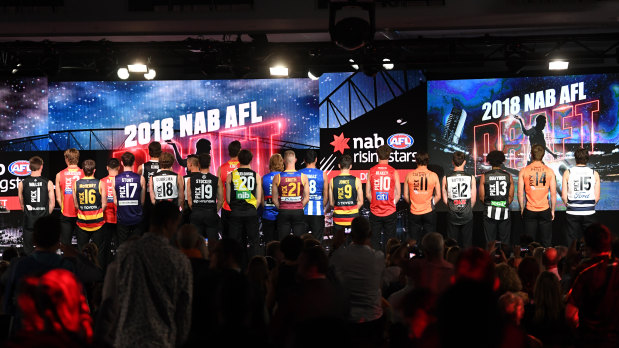 The 2018 AFL draft's top 21 selections try on their new colours.