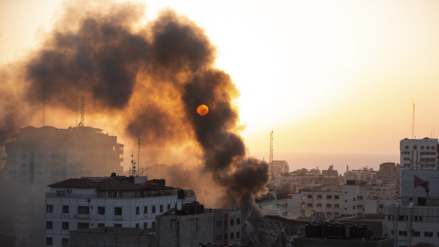 Smoke is seen from a collapsed building after it was hit by Israeli airstrikes on Gaza City.