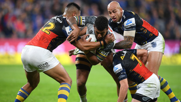 Ferguson helps bring down Viliame Kikau during a disappointing performance against the Panthers. 