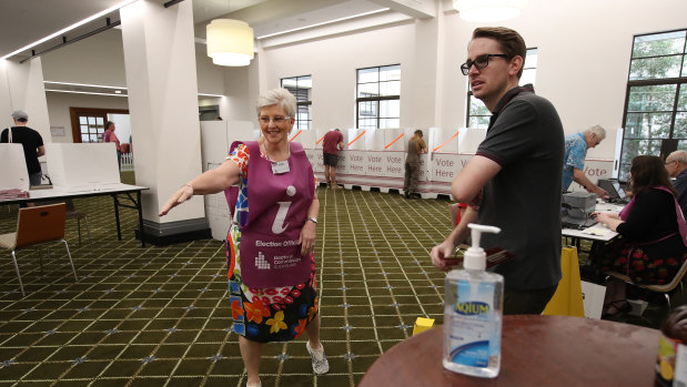 An election official directs voters at Brisbane City hall polling booth.