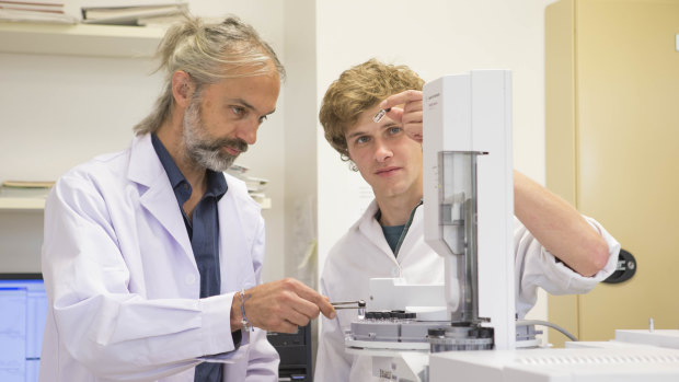 Associate Professor Jochen Brocks with PhD candidate Ilya Bobrovskiy, both from the ANU Research School of Earth Sciences, work in their lab analysing rock samples. 