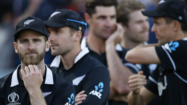 Kane Williamson (left) and teammates react during the World Cup presentation ceremony.