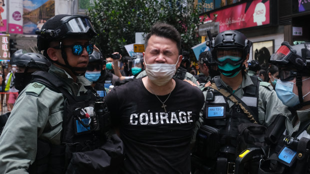 Andrew Wan, a pro-democracy legislator, is arrested by riot police during a protest in Hong Kong on Wednesday.