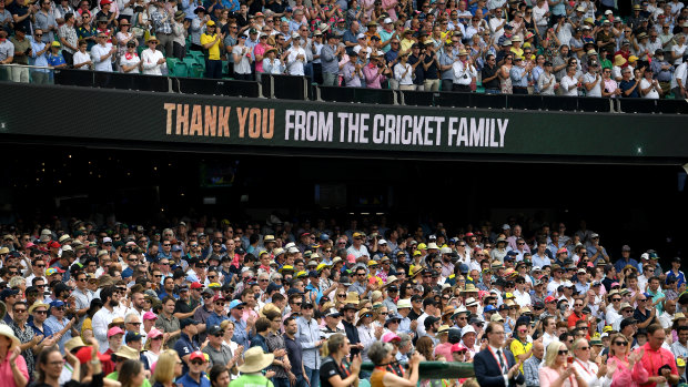 Spectators stand for a minute's applause at the SCG.