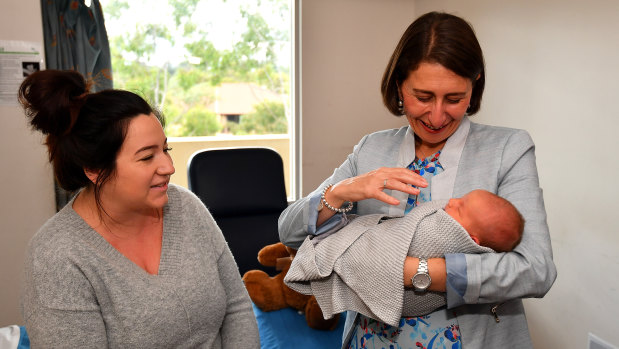 Gladys Berejiklian holds baby Jordan Hiley alongside mother Lauren Mitchell during the Premier's visit to Blacktown Hospital on Thursday.
