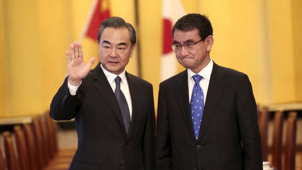 Chinese Foreign Minister Wang Yi and his Japanese counterpart Taro Kono in Tokyo on Sunday.
