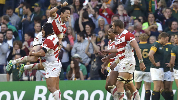 Japan's Brave Blossoms celebrate their upset win over South Africa at the 2015 Rugby World Cup.