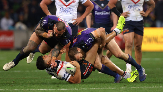 Nelson Asofa-Solomona puts a hit on Roosters winger Joseph Suaalii.