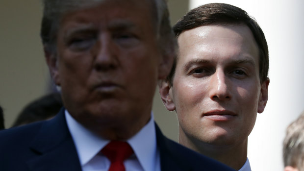 White House senior adviser Jared Kushner, right, stands behind President Donald Trump.