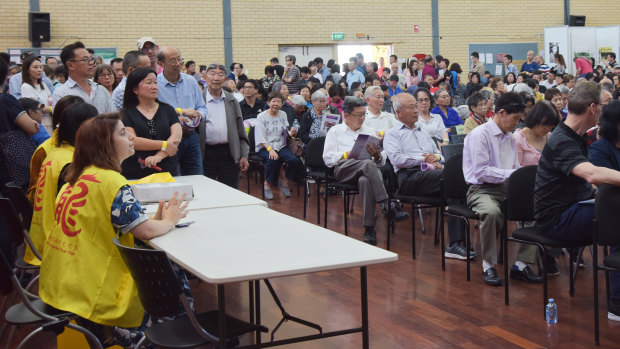 Chung Wah members line up waiting to vote for a new president at Saturday's annual general meeting.