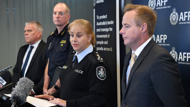 Queensland Police and Australian Border Force officers address the media on Friday. 