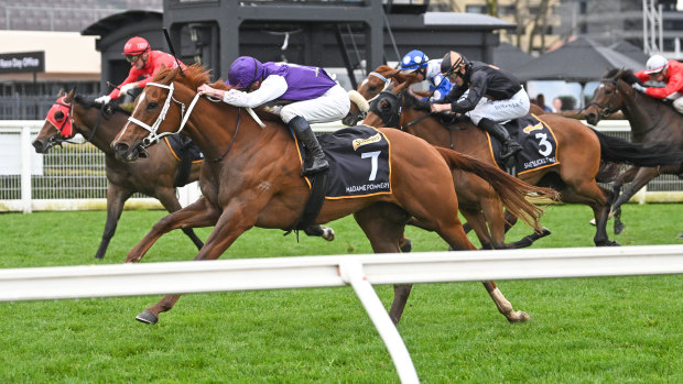 Madame Pommery, ridden by James McDonald, wins the Thousand Guineas.