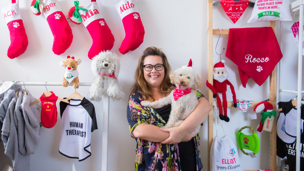 IDPet founder Katrina Thomson, with Sid, with some of the products she sells for Christmas. 