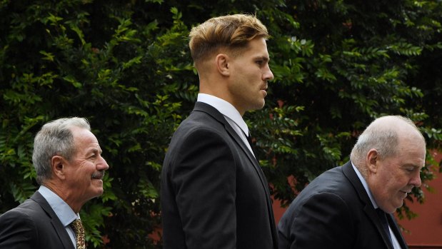 Jack de Belin (centre) has pleaded not guilty to multiple charges of sexual assault.