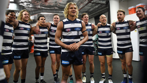 Quinton Narkle (centre) stands with his Geelong teammates as they sing the team song in Sydney.