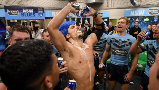 A hard-earned thirst: Jack De Belin slams down two beers at once.
