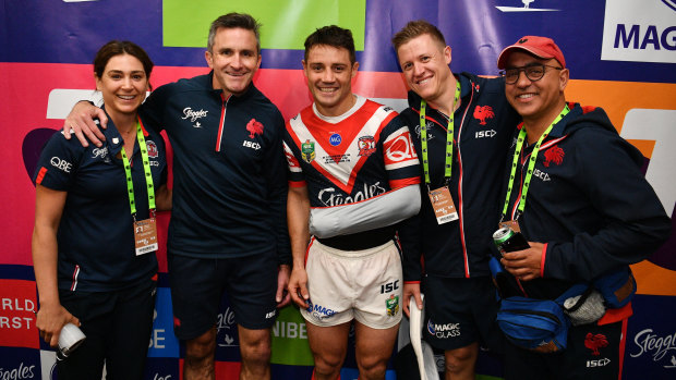 Miracle workers: Cronk with the Roosters' medical staff, who got the halfback in shape to take the field for the grand final despite a badly broken shoulder blade.