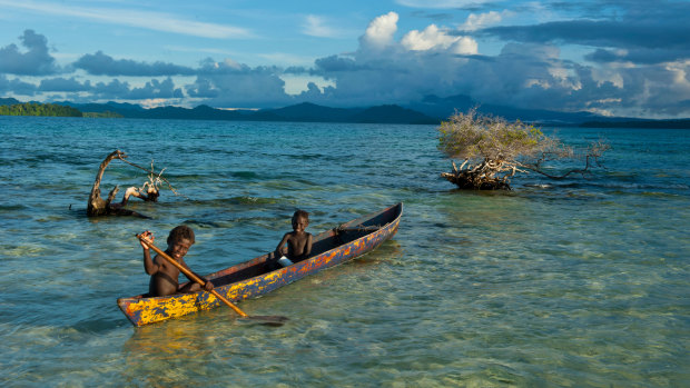 Boys fish in the Marovo Lagoon in the Solomon Islands.