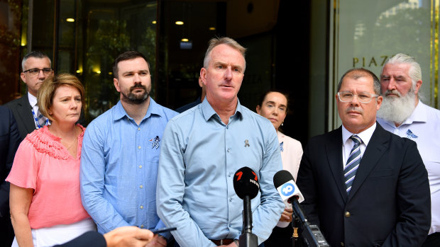 Andrew Prestney (centre), the father of Constable Josh Prestney, outside the Downing Centre Local Court on Tuesday.