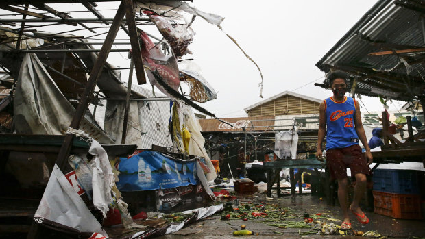 A resident walks along destroyed stalls at a public market due to strong winds as typhoon Mangkhut barrelled across Tuguegrao in Cagayan province, Philippines.