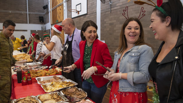 NSW Premier Gladys Berejiklian serving breakfast to RFS volunteers at Colo Heights High School on Christmas morning. 