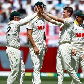 Brendan Doggett (right) and Travis Head celebrate the wicket of England’s Harry Brook.