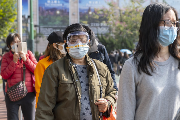 Residents in Hong Kong on Saturday line up to buy more protective masks.