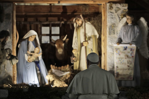 Pope Francis stops to view the Nativity scene in St Peter's Square.