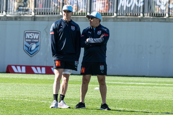 Dylan Edwards watches on at training on Monday while standing with Blues’ footy manager Frank Ponissi.