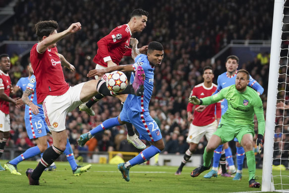 United’s Harry Maguire (left) attempts a shot at goal against Atletico Madrid.