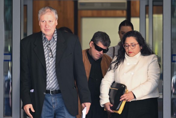 Maria James’ sons Mark James (left) and Adam James (brown jacket) with lawyer Naty Guerrero-Diaz on Thursday.